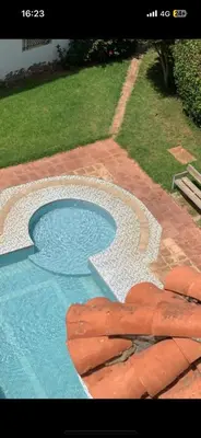 a small swimming pool with a stone walkway around it at residence le litoral 1 in Oulad Akkou