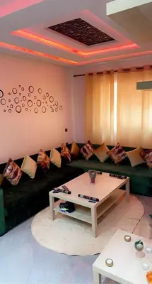 a living room with a couch and a table at Appartement exceptionnel a louer in Oulad Akkou
