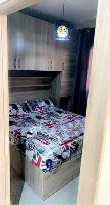 a bedroom with a bed with a british flag bedspread at Appartement exceptionnel a louer in Oulad Akkou