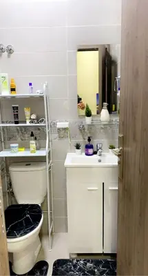 a bathroom with a toilet and a sink and a mirror at Appartement exceptionnel a louer in Oulad Akkou