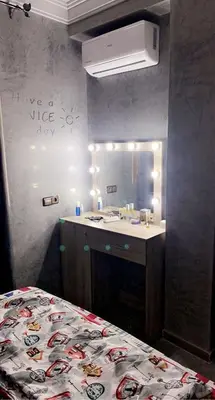 a bathroom with a bed and a sink and a mirror at Appartement exceptionnel a louer in Oulad Akkou