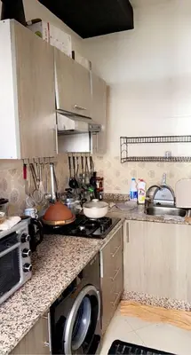 a kitchen with a sink and a stove top oven at Appartement exceptionnel a louer in Oulad Akkou