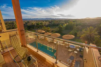 a balcony with a view of a resort at Maison d'hôte IGRANE in Tinerhir