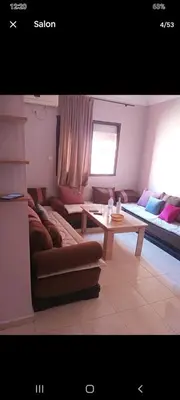 a living room with a couch and a table at Apparemment en résidence à 10 mns de Gueliz in Oulad Akkou