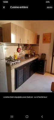 a kitchen with a stove and a refrigerator at Apparemment en résidence à 10 mns de Gueliz in Oulad Akkou