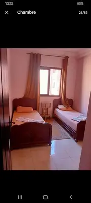a bedroom with two beds and a window at Apparemment en résidence à 10 mns de Gueliz in Oulad Akkou