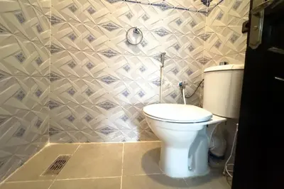 a bathroom with a white toilet in a room at Villa Jenane Rabia in Amezrou