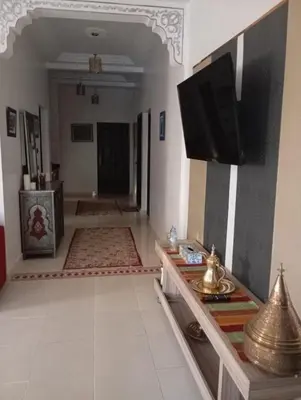 a living room with a flat screen tv on a wall at Villa Jenane Rabia in Amezrou