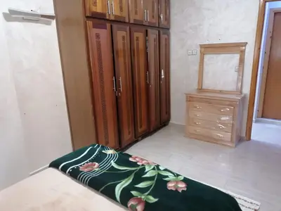 a room with lockers and a dresser and a mirror at Aicha's appartement 1 in Meknès