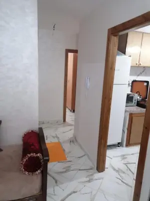 a living room with a floor covered in marble at Aicha's appartement 1 in Meknès
