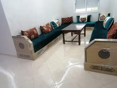 a living room with a couch and a table at Aicha's appartement 1 in Meknès