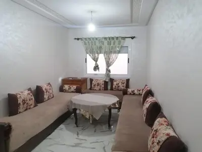 a living room with a couch and a table at Aicha appartement 2 in Meknès