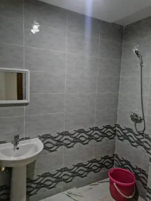 a bathroom with a sink and a shower at Aicha appartement 2 in Meknès
