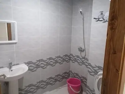 a bathroom with a sink and a toilet and a shower at Aicha appartement 2 in Meknès