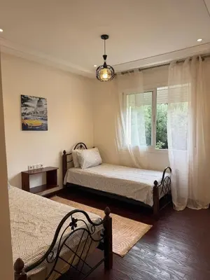 a bedroom with two beds and a window at Dar Dina Havre de paix sous les cèdres d'Ifrane in Ifrane
