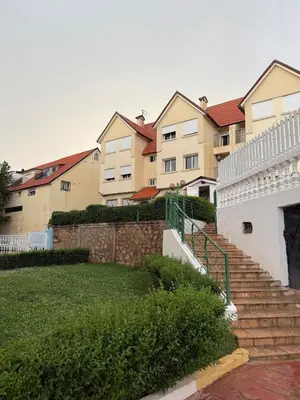 a set of stairs in a yard with houses at Dar Dina Havre de paix sous les cèdres d'Ifrane in Ifrane