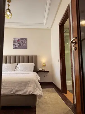 a bedroom with a bed and a glass door at Dar Dina Havre de paix sous les cèdres d'Ifrane in Ifrane