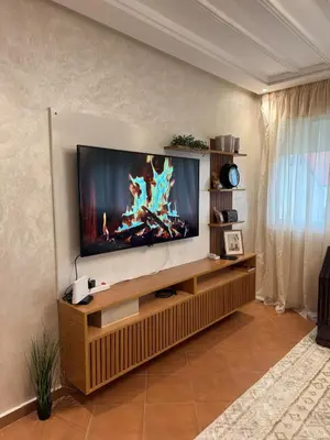 a living room with a flat screen tv on a wall at Dar Dina Havre de paix sous les cèdres d'Ifrane in Ifrane