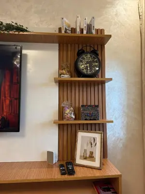 a shelf with a clock on a wall at Dar Dina Havre de paix sous les cèdres d'Ifrane in Ifrane