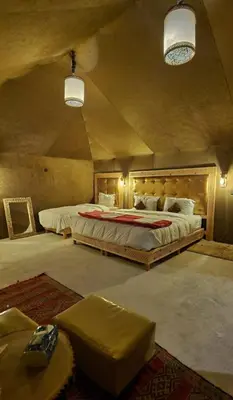 a bedroom with a large bed in a room at fabulousluxurycamp in Merzouga