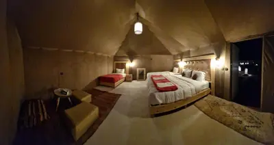 a view of a bedroom with a bed and a couch at fabulousluxurycamp in Merzouga