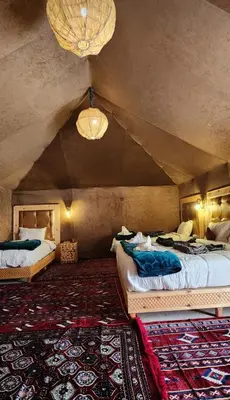 a bedroom with two beds in a room at fabulousluxurycamp in Merzouga