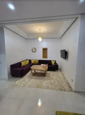 a living room with a couch and a coffee table at Mansbay Beach in Oulad Akkou