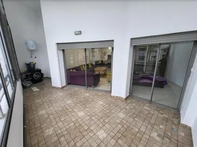 a room with three glass doors and a tiled floor at Mansbay Beach in Oulad Akkou