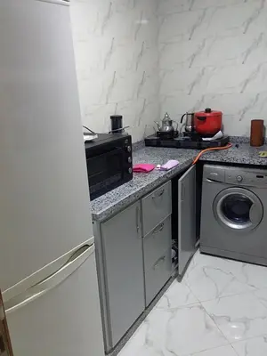 a kitchen with a refrigerator and a washing machine at Appartement A Martil in Oulad Akkou