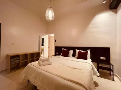 a bedroom with a large bed with a towel on it at Relax Family 01 - Cozy Entire Apartement in City Center in Ouarzazate