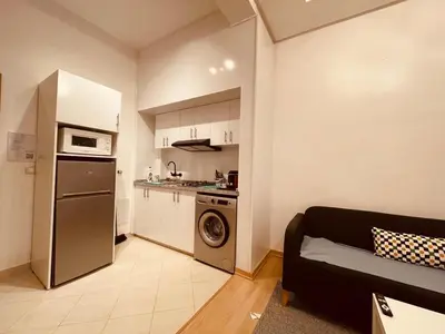 a living room with a couch and a kitchen at Relax Family 01 - Cozy Entire Apartement in City Center in Ouarzazate