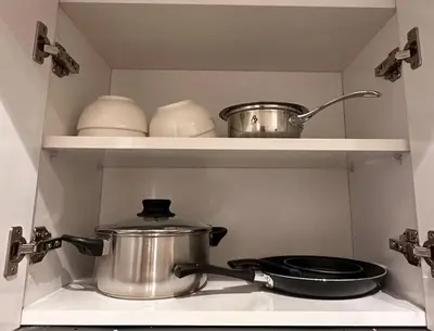 a pot and pans on a shelf in a kitchen at Relax Family 01 - Cozy Entire Apartement in City Center in Ouarzazate