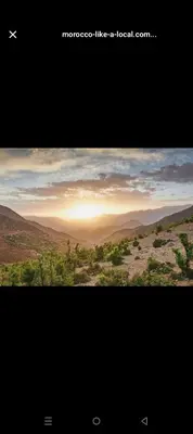 a picture of a desert with the sun setting in the horizon at Morocco Tour Itineraries in Merzouga