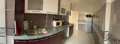 a kitchen with a sink and a microwave at Appartement in Beni Mellal