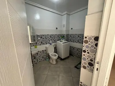 a bathroom with a toilet and a sink at Appartement in Beni Mellal