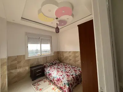 a bedroom with a bed and a window at Appartement in Beni Mellal