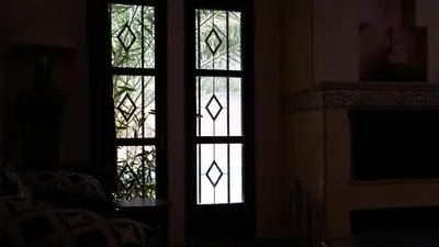 two stained glass windows in a room with a fireplace at Villa Zazate private pool & starry garden in Ouarzazate