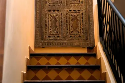 a set of stairs with a large wooden door at Villa Zazate private pool & starry garden in Ouarzazate
