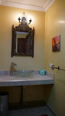 a bathroom with a sink and a mirror on the wall at Villa Zazate private pool & starry garden in Ouarzazate