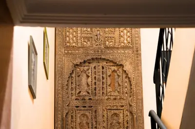 an ornate gold door in a wall at Villa Zazate private pool & starry garden in Ouarzazate