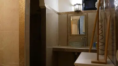 a bathroom with a sink and a mirror at Villa Zazate private pool & starry garden in Ouarzazate