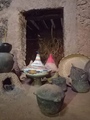 a group of bowls and vases sitting in a room at Auberge merzouka in Rissani