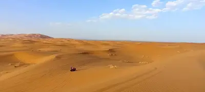 a group of people on a camel in the desert at Auberge merzouka in Rissani