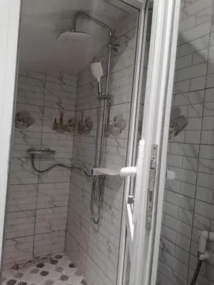 a bathroom with a shower with a glass door at Elbatoir in Oulad Akkou