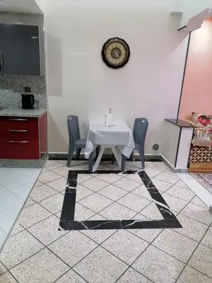 a dining room with a white table and chairs at Elbatoir in Oulad Akkou