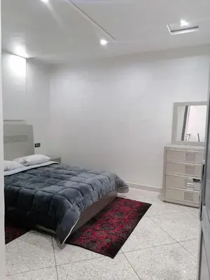 a bedroom with a bed and a dresser and a mirror at Elbatoir in Oulad Akkou