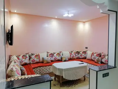 a living room with a couch and a table at Elbatoir in Oulad Akkou