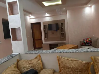 a living room with a couch and a flat screen tv at Chokri lamia in Ouled Khellouf