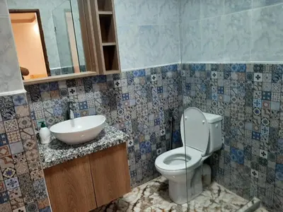 a bathroom with a toilet and a sink at Chokri lamia in Ouled Khellouf