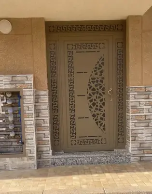 a front door of a building with a design on it at AMB appartements in Oulad Akkou
